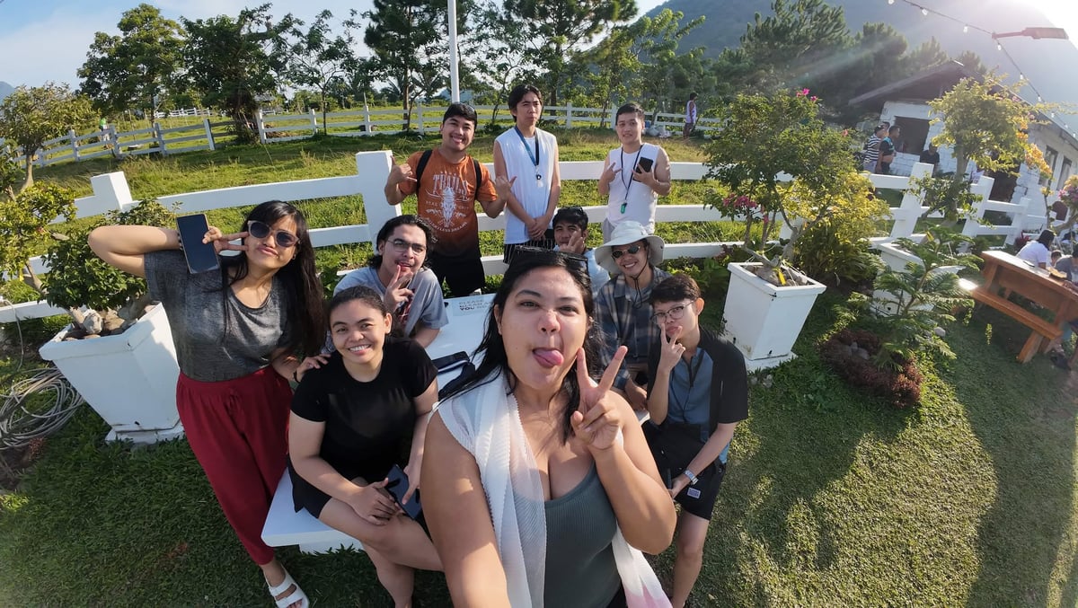 The NorthQA team at a hilltop viewpoint in Camiguin at golden hour