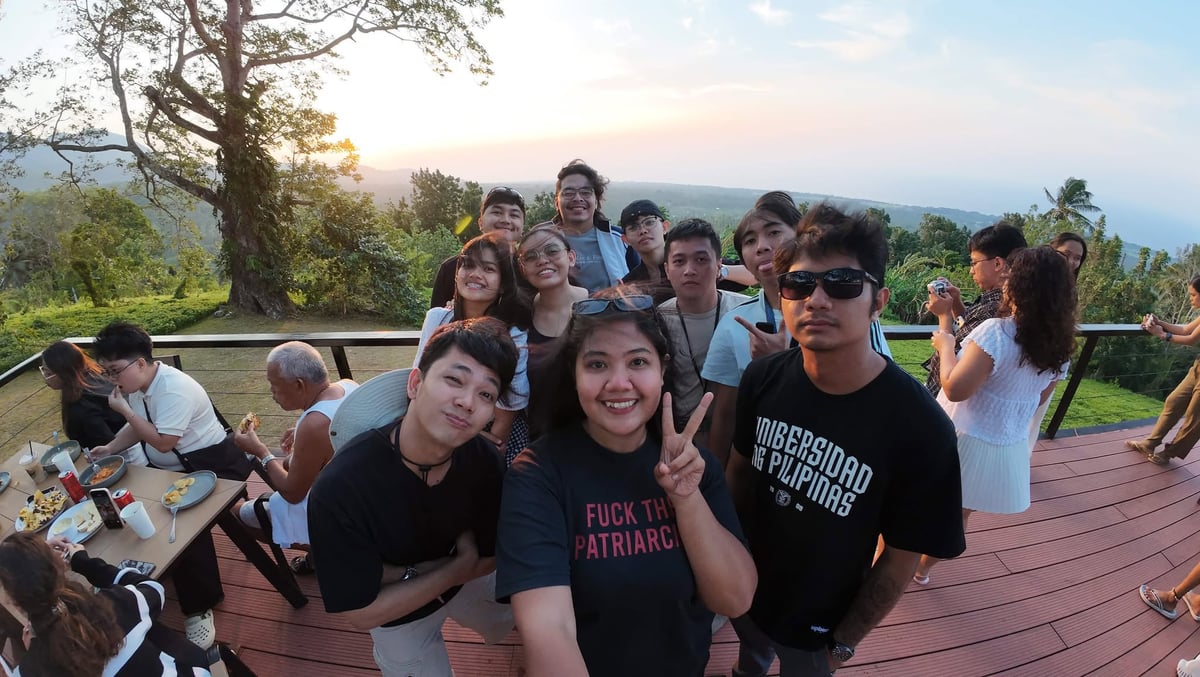 The NorthQA team at a cafe deck in Camiguin at sunset
