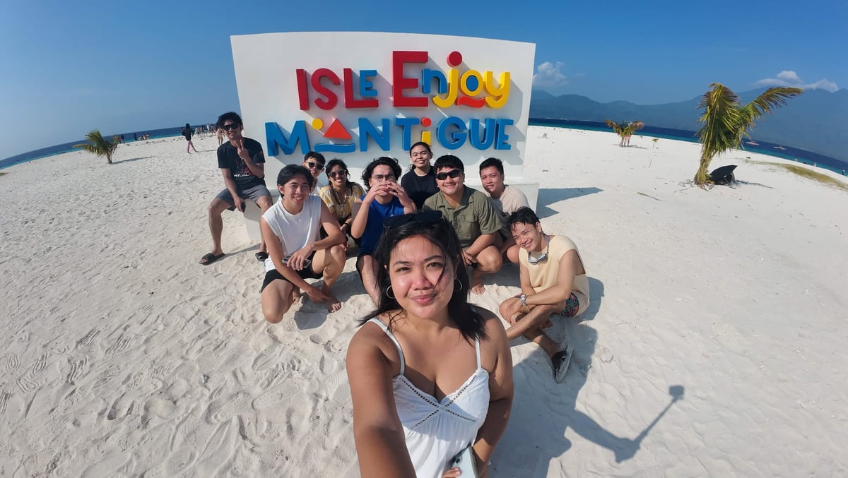 The NorthQA team at the Isle Enjoy Mantigue sign on white sand